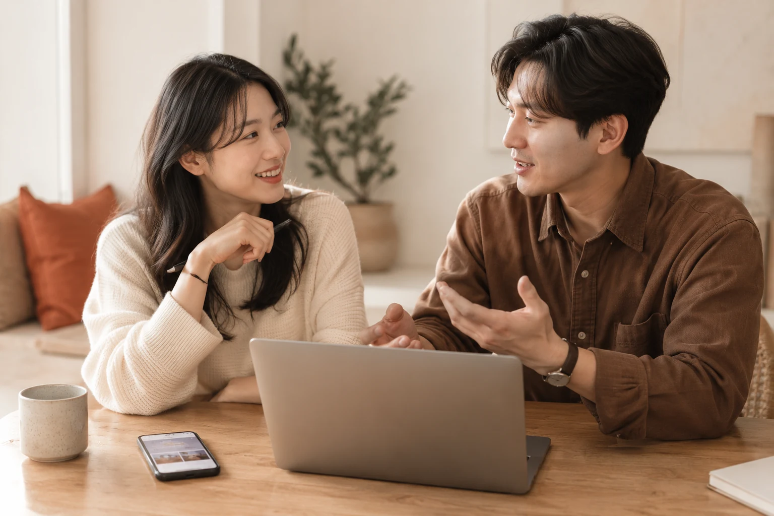 노트북을 앞에 두고 구글 키워드 플래너 결과로 광고 계획을 이야기하는 두 사람